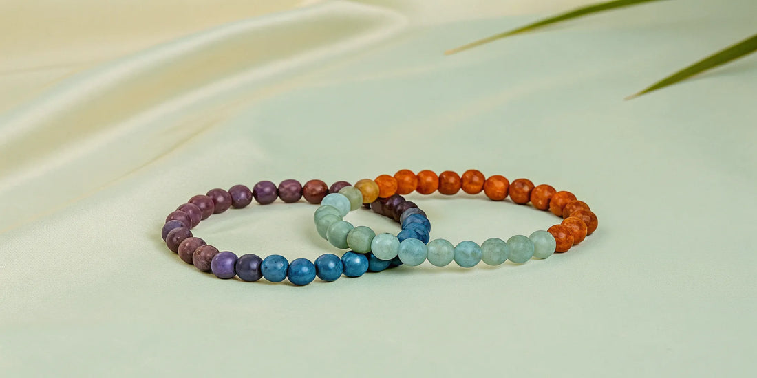 Coloured gemstone bracelets with purple, blue, green, and orange beads.