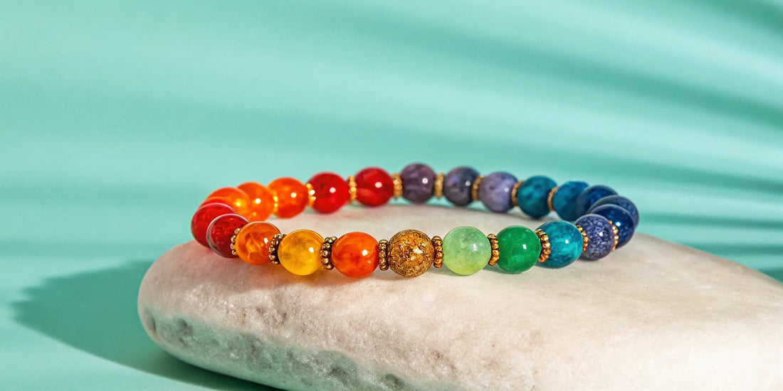 Real 7 chakra stone bracelet on white surface.