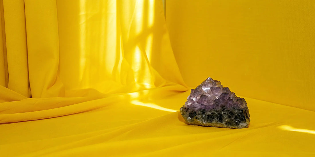 Amethyst cluster on gold fabric.