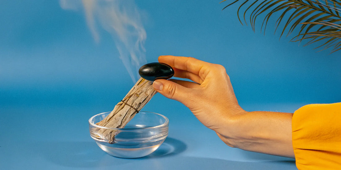 Cleansing black tourmaline with smudging stick.