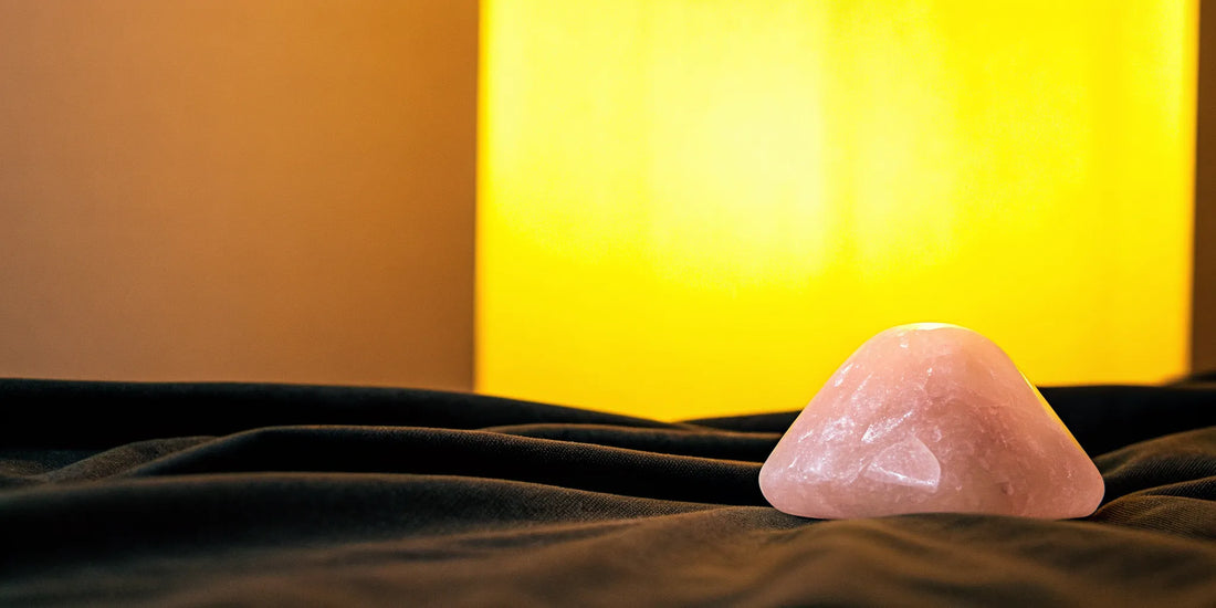 Rose quartz crystal on dark background.