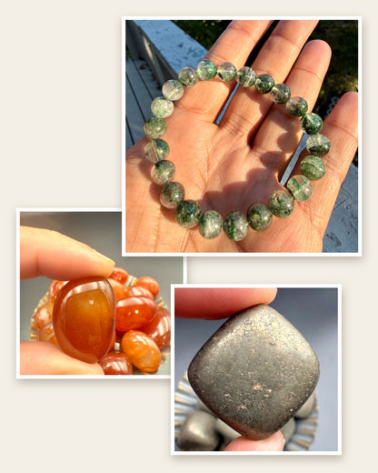 Green phantom quartz bracelet in an open hand, with a carnelian and a pyrite tumbled stone held in fingertips: the three pieces in the First Day Set