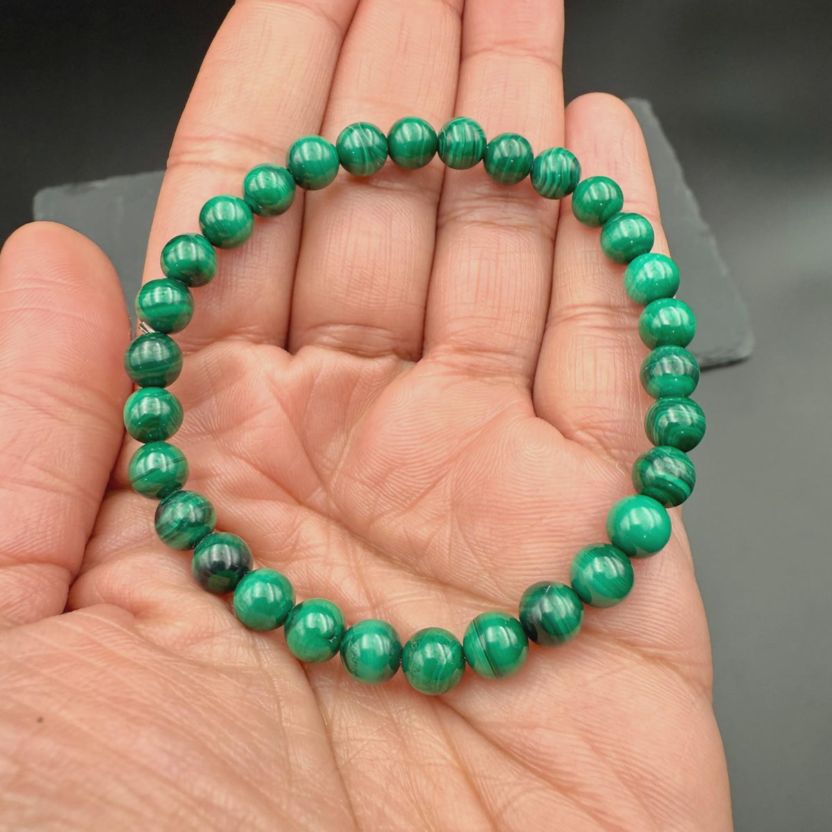 Malachite bracelet held in an open palm