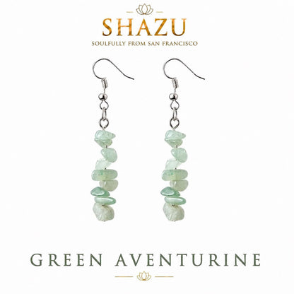 May include: A pair of drop earrings featuring silver-toned fishhook wires and a vertical arrangement of tumbled, pale green aventurine stone chips. The text SHAZU SOULFULLY FROM SAN FRANCISCO and GREEN AVENTURINE is visible above and below the earrings.