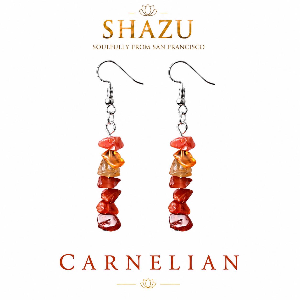 May include: A pair of drop earrings featuring silver-toned fishhook wires and a vertical stack of raw, tumbled carnelian gemstone chips in shades of orange and red. The text SHAZU SOULFULLY FROM SAN FRANCISCO and CARNELIAN is visible.