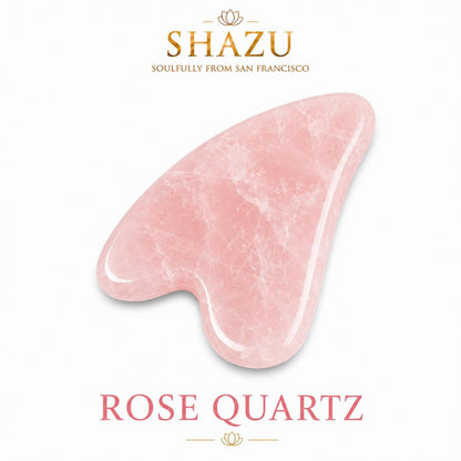 May include: A heart-shaped rose quartz gua sha tool with a smooth, polished surface and natural crystalline texture. The text SHAZU SOULFULLY FROM SAN FRANCISCO appears above the stone, and the text ROSE QUARTZ is printed in pink below the stone.