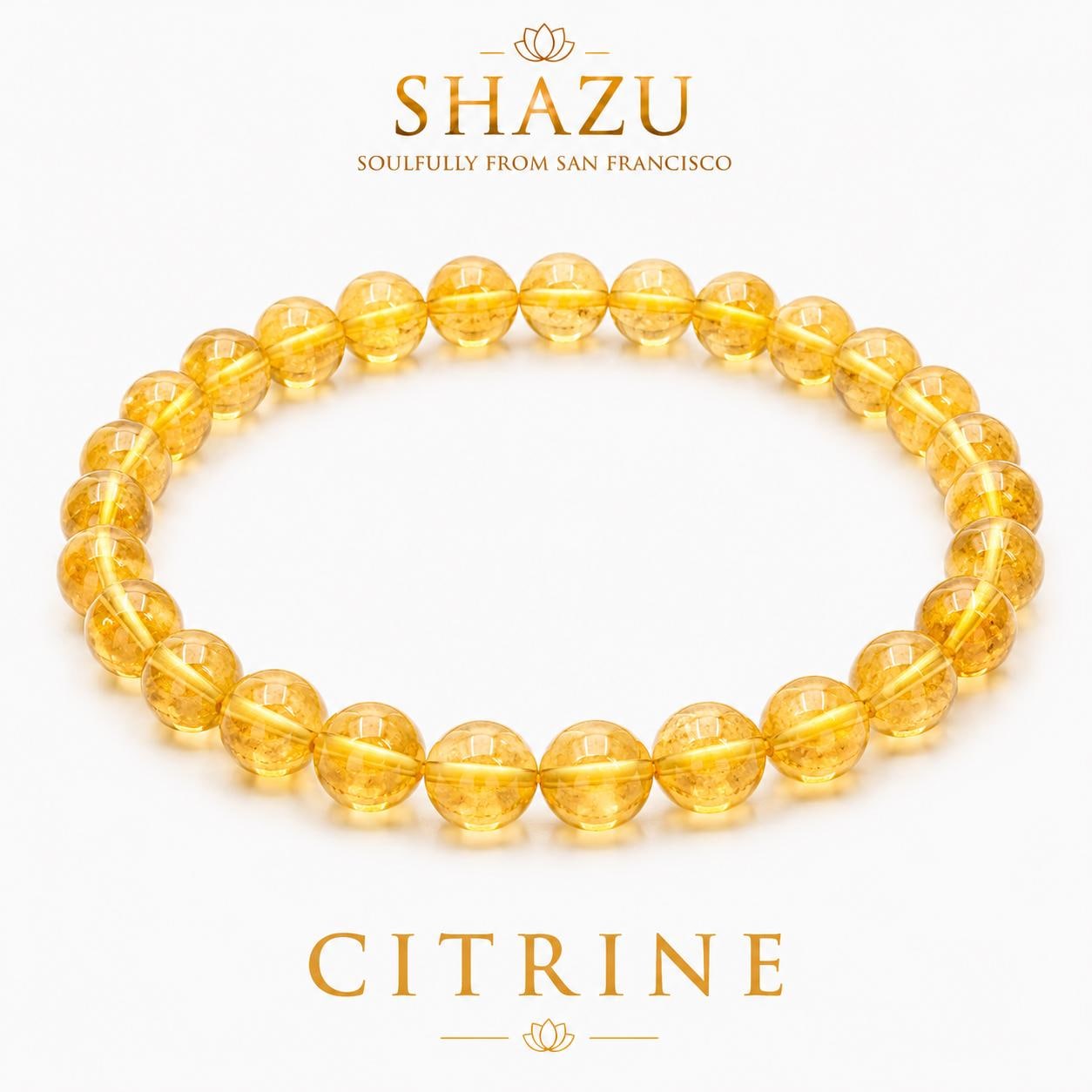 May include: A circular bracelet composed of translucent, golden-yellow citrine beads. Above the bracelet, the text reads SHAZU SOULFULLY FROM SAN FRANCISCO. Below the bracelet, the text reads CITRINE. The beads are uniform in size and shape.