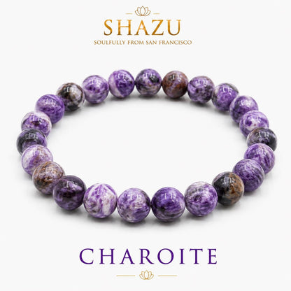 May include: A circular beaded bracelet made of polished, round charoite stones featuring swirling patterns of deep purple, violet, and black. The text SHAZU SOULFULLY FROM SAN FRANCISCO and CHAROITE is printed in gold and purple above and below the bracelet.