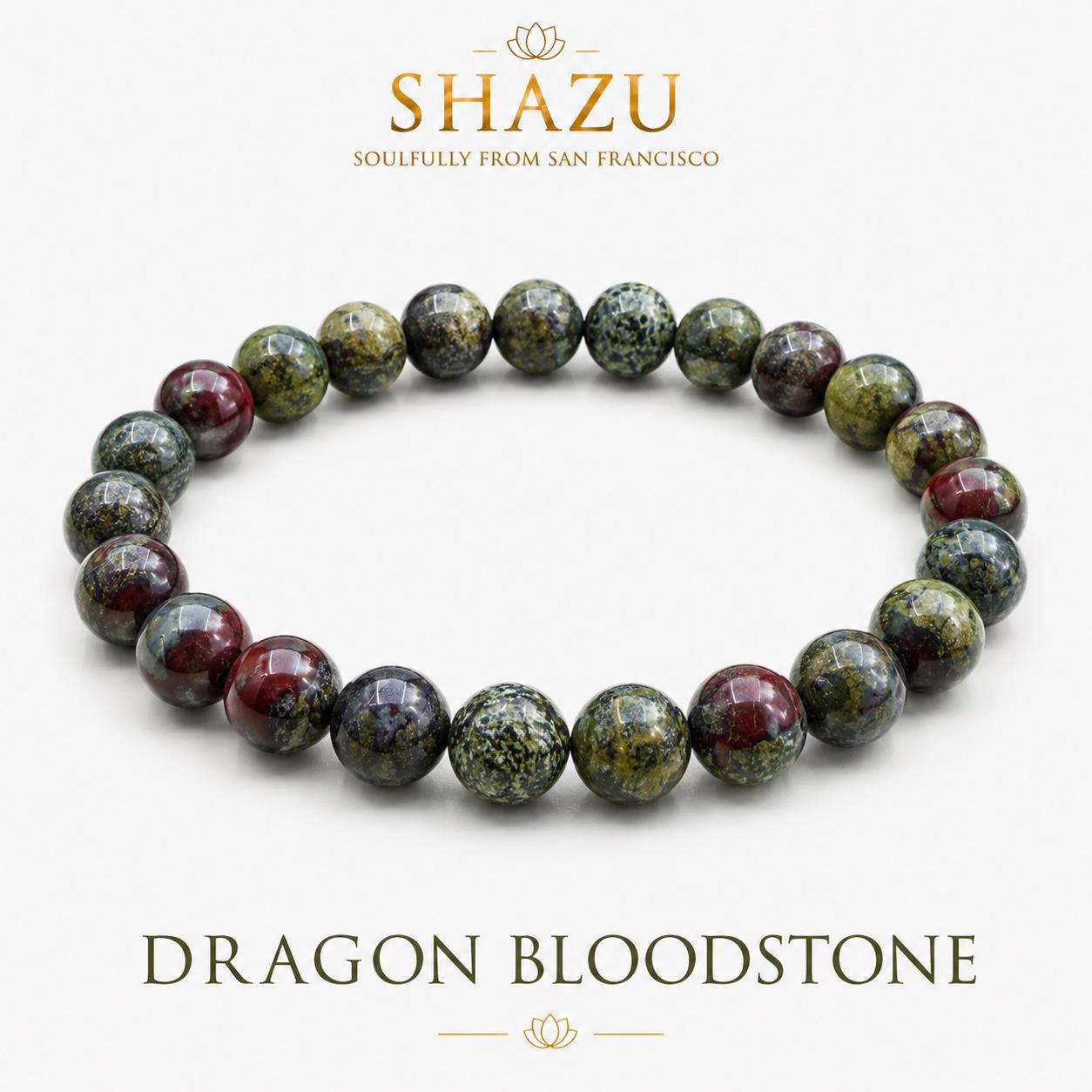 May include: A beaded bracelet made of round, polished dragon bloodstone beads featuring a mottled pattern of deep forest green, olive, and dark crimson red. The text SHAZU SOULFULLY FROM SAN FRANCISCO and DRAGON BLOODSTONE is visible in the image.