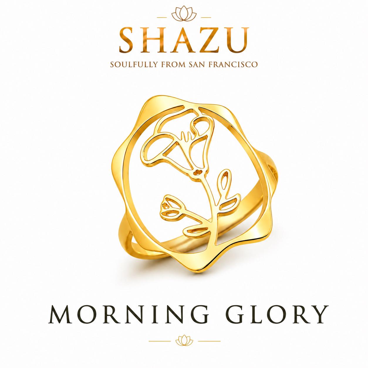 May include: A gold ring featuring a cutout design of a morning glory flower within a scalloped circular frame. The text SHAZU SOULFULLY FROM SAN FRANCISCO appears above the ring, and the text MORNING GLORY is printed below the jewelry piece.